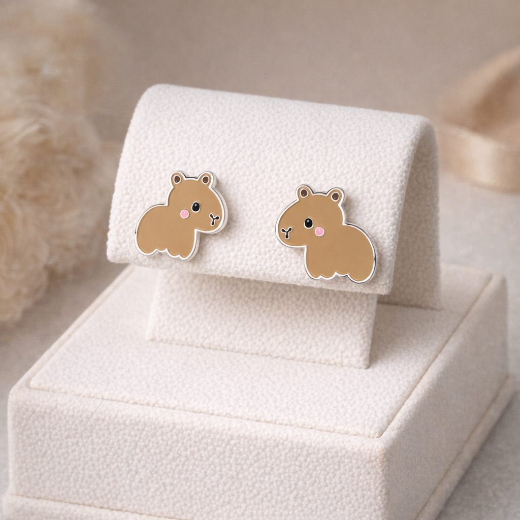 Melchior Jewellery capybara earrings for girls in soft brown with cute pink cheeks on white display stand