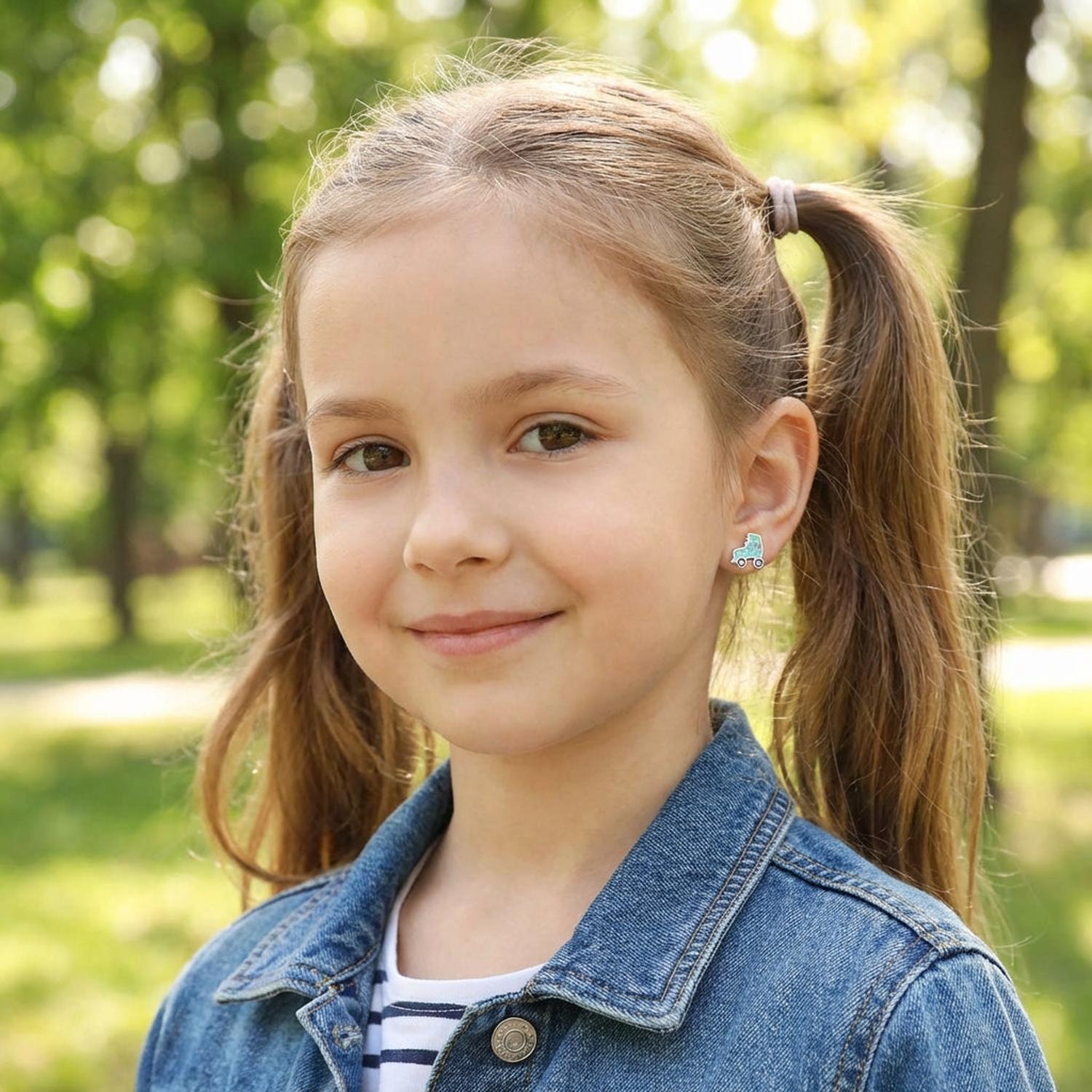 Young girl wearing sterling silver girls roller skate earrings by Melchior Jewellery outdoors