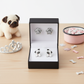 Cute pet themed earrings for children by Melchior Jewellery featuring dog and paw designs in a black box