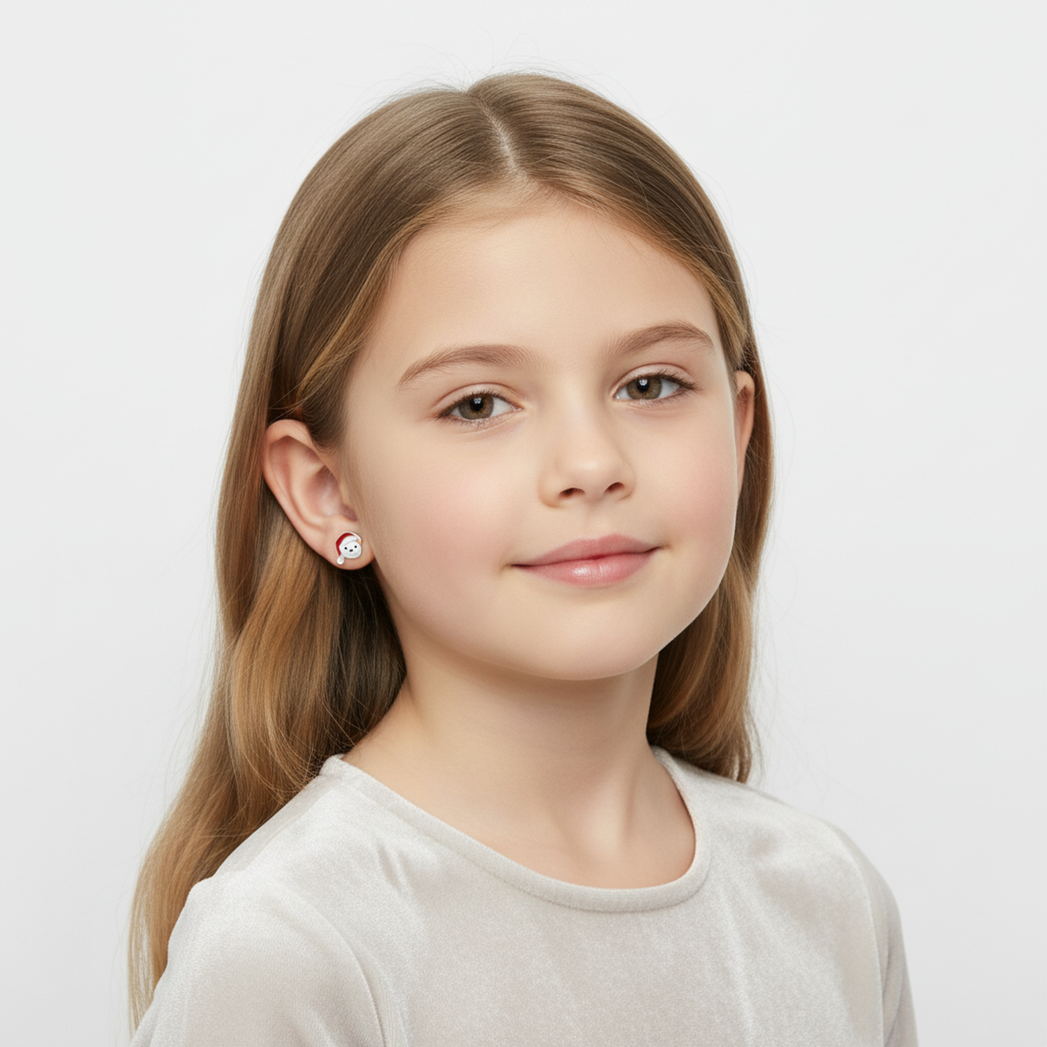Child wearing sterling silver Santa bear earrings by Melchior Jewellery on a white background