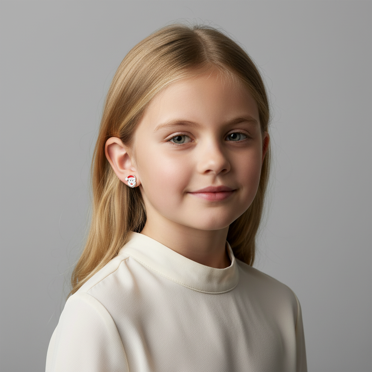 Young girl wearing Melchior Jewellery Santa earrings for kids with festive design in white top