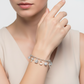 cz 13 charms bracelet for women by Melchior Jewellery featuring silver charm details on model's wrist