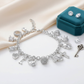 Melchior Jewellery cz 13 charms bracelet for women with silver charms including cross heart crown and key