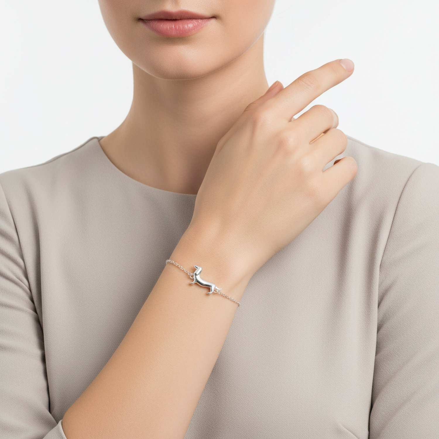 Sterling silver dachshund bracelet by Melchior Jewellery worn on wrist with delicate chain