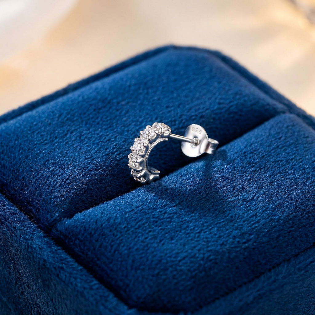 925 sterling silver mens CZ half hoop stud earring with sparkling cubic zirconia stones displayed on navy blue velvet by Melchior Jewellery