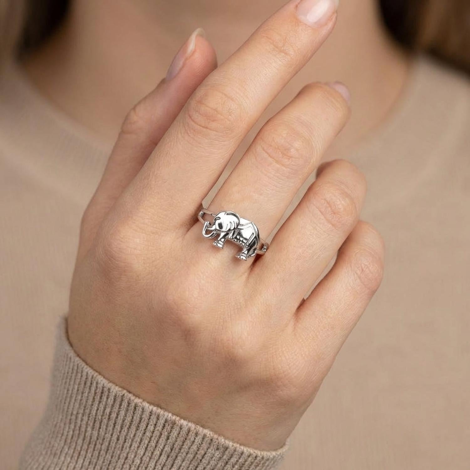 Sterling silver elephant ring worn on a womans hand featuring detailed elephant design by Melchior Jewellery