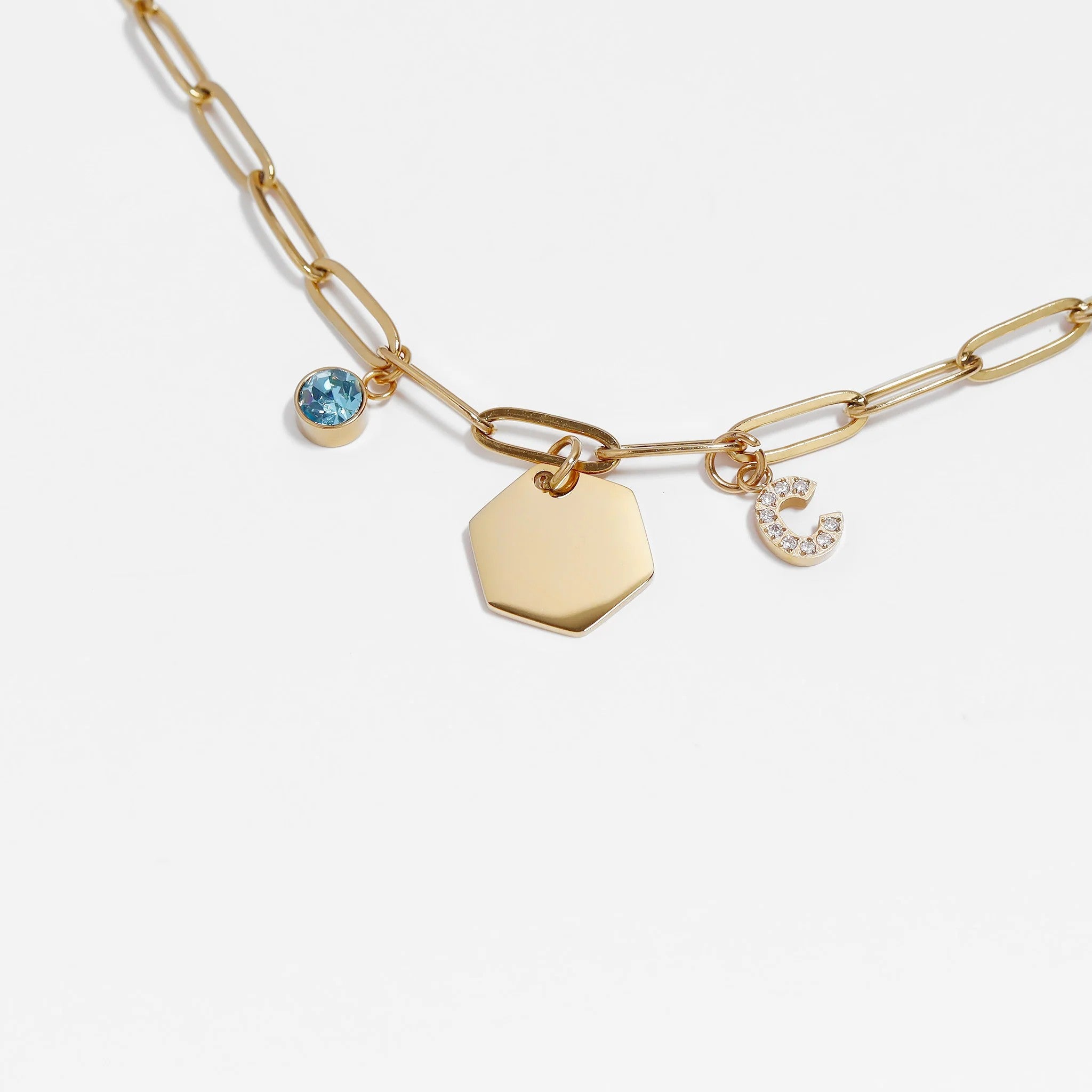Gold tone stainless steel birthstone charm bracelet with blue gem and letter c charm