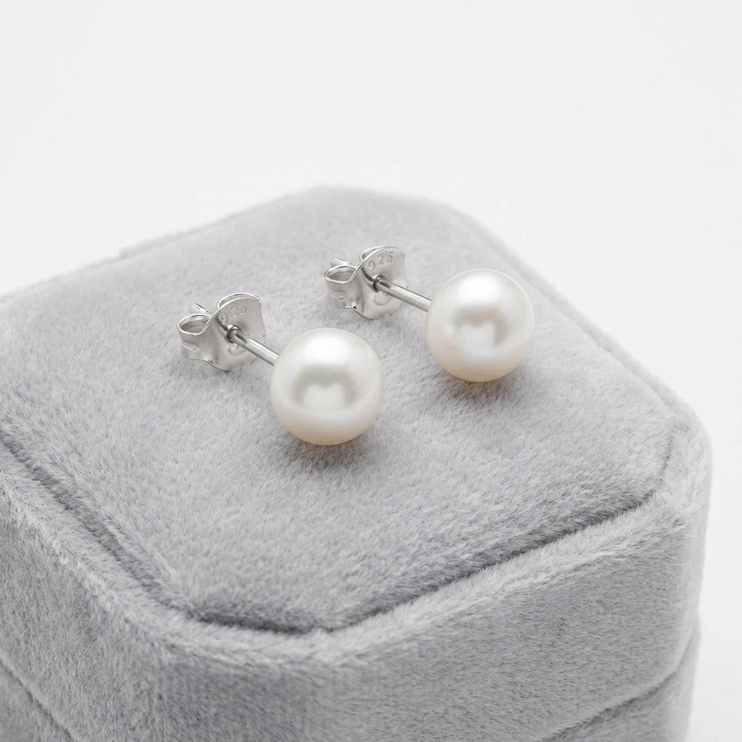 Melchior Jewellery sterling silver pearl stud earrings displayed on grey velvet box