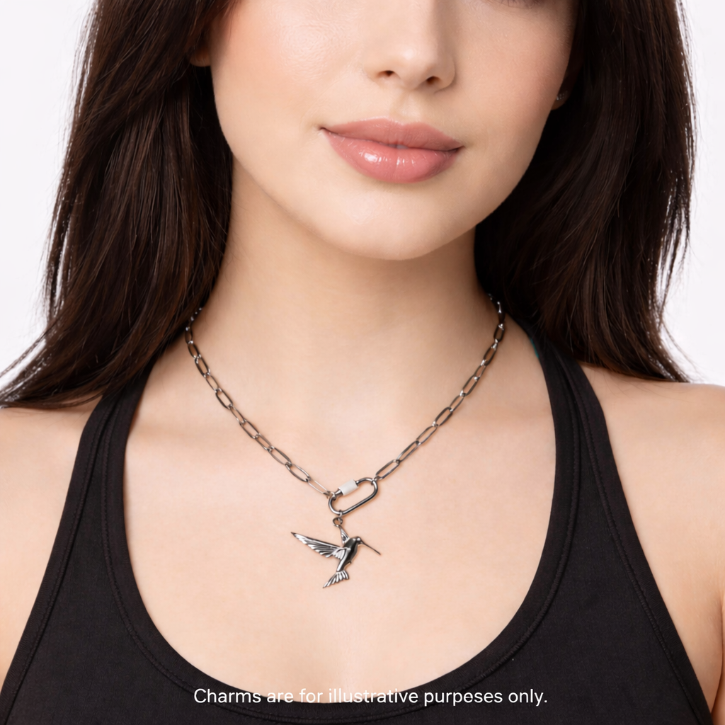 Melchior Jewellery stainless steel carabiner necklace with silver hummingbird charm worn by woman in black top