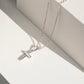 Girls sterling silver cross necklace and earrings from Melchior Jewellery displayed on white background