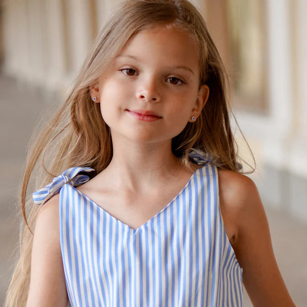 Young girl wearing 4mm silver screw back earrings from In Season Jewellery in a blue striped dress