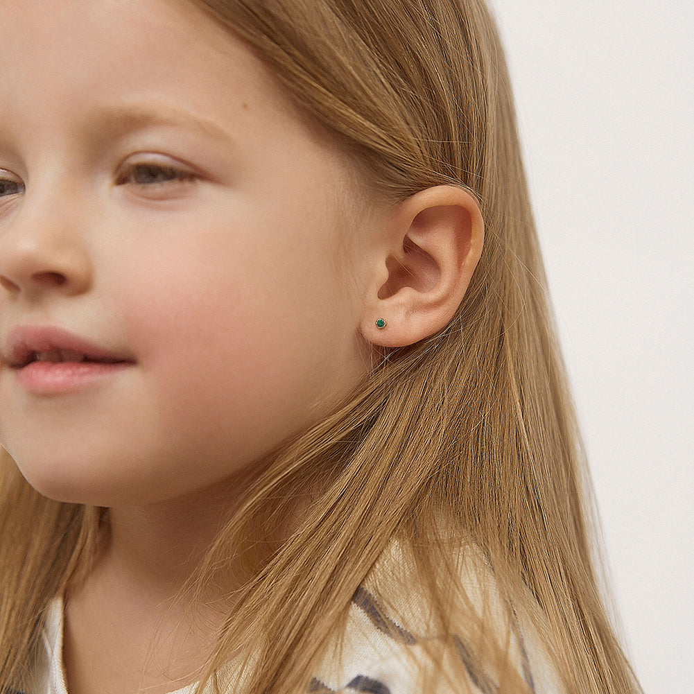 In Season Jewellery emerald green screw back earrings for children worn by young girl with long blonde hair