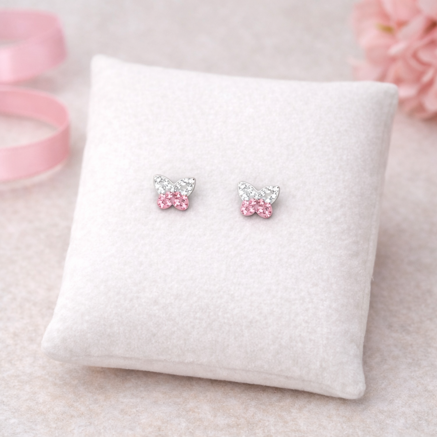 Melchior Jewellery kids butterfly earrings with crystals in pink and clear stones on white cushion