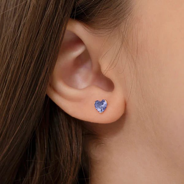 Heart-shaped kids gold birthstone jewellery UK blue stud earrings worn by child