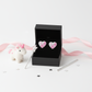 Melchior Jewellery kids heart-shaped silver earrings in black box with pink and white unicorn toy