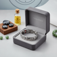 Silver titanium magnetic bracelet by Melchior Jewellery displayed in grey gift box with essential oils and stones