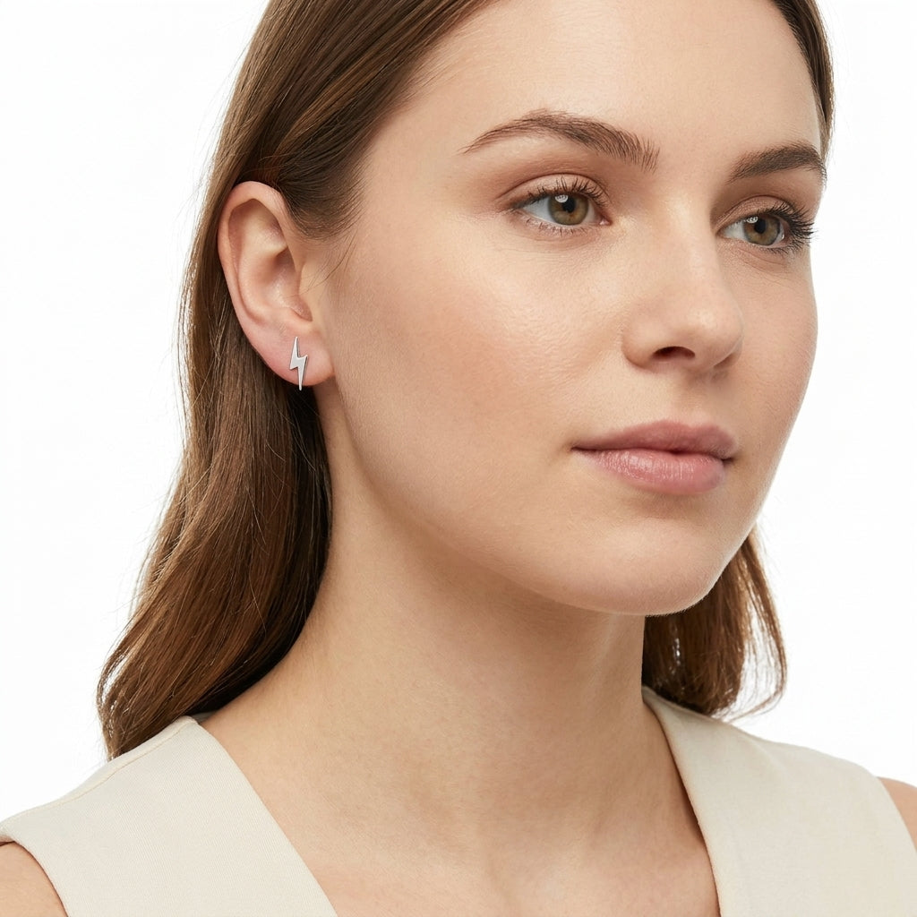 Melchior Jewellery sterling silver lightning bolt earrings worn by woman with fair skin and brown hair