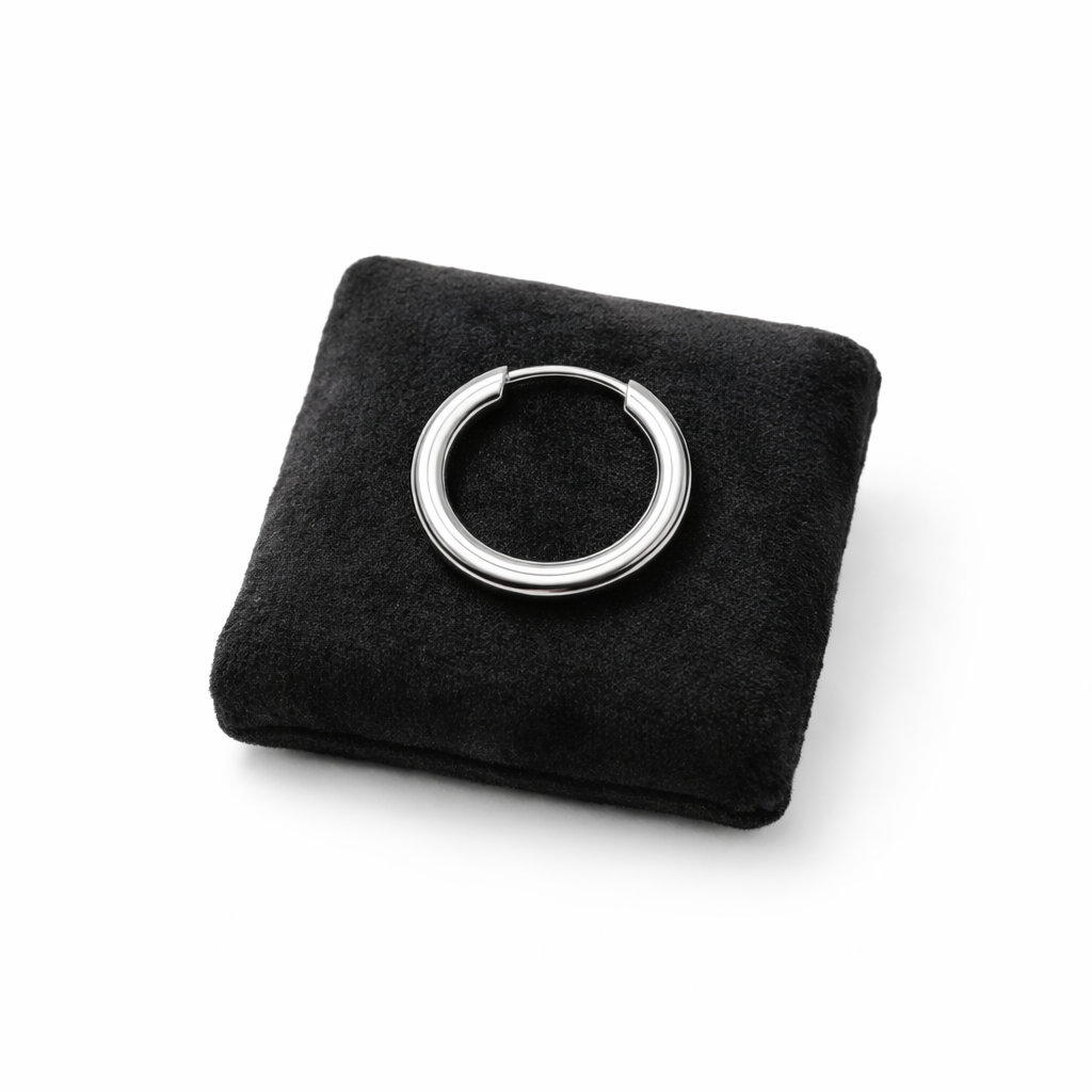 18mm mens hoop earring in polished silver displayed on a black velvet cushion by Melchior Jewellery