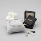 925 silver baby torque bracelet displayed on grey cushion with white baby booties and Melchior Jewellery box