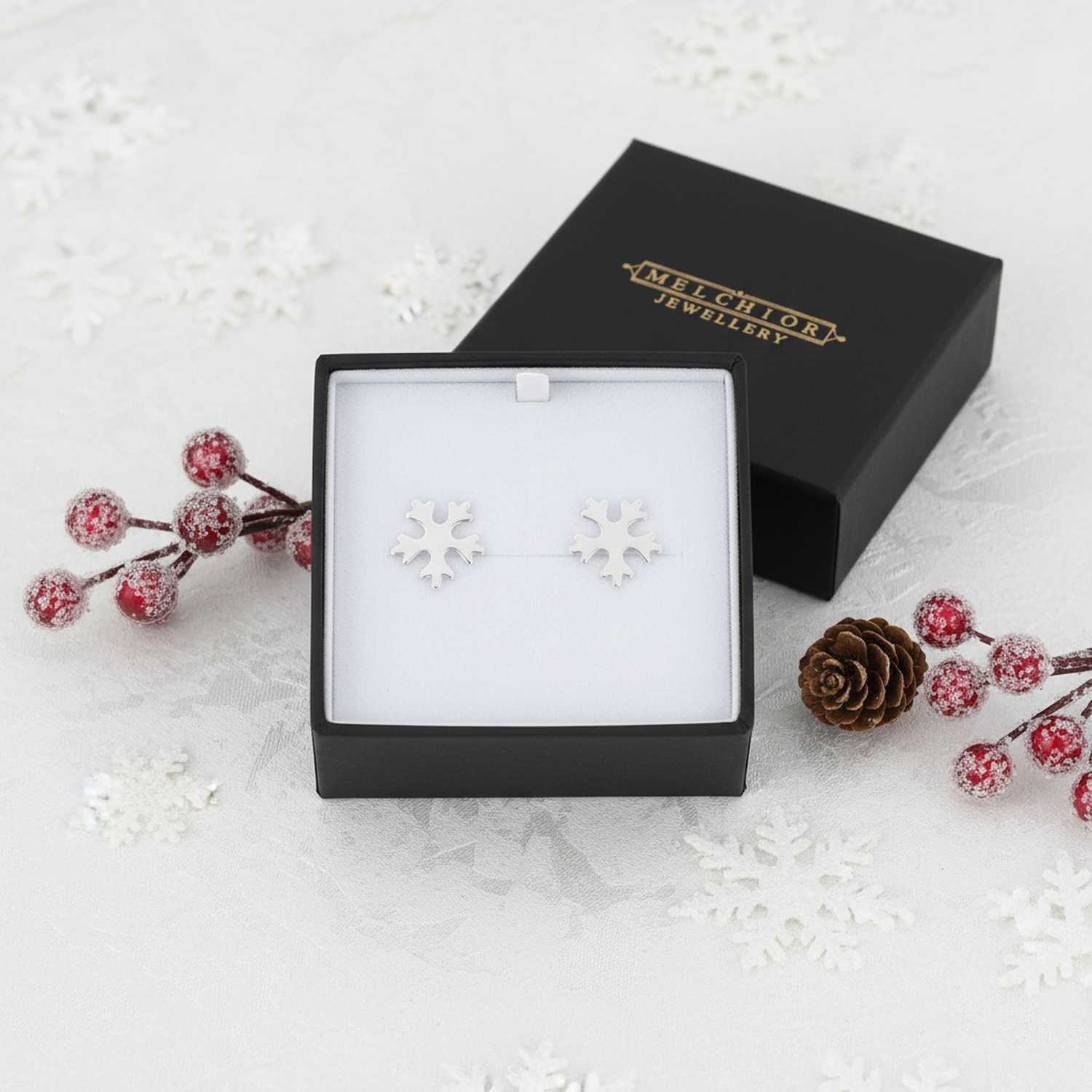 925 sterling silver snowflake earrings by Melchior Jewellery displayed in a black gift box with festive decor