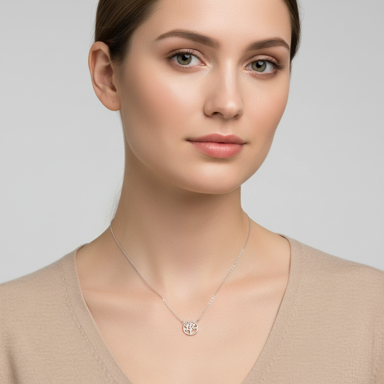 Woman wearing 925 sterling silver tree of life necklace by Melchior Jewellery with delicate chain and pendant