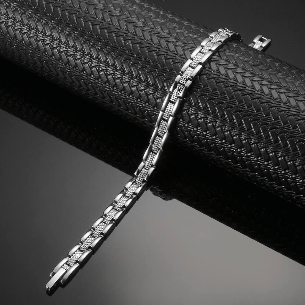 Affinity stainless steel 4 in 1 therapy bracelet by Melchior Jewellery with sleek silver links on black background