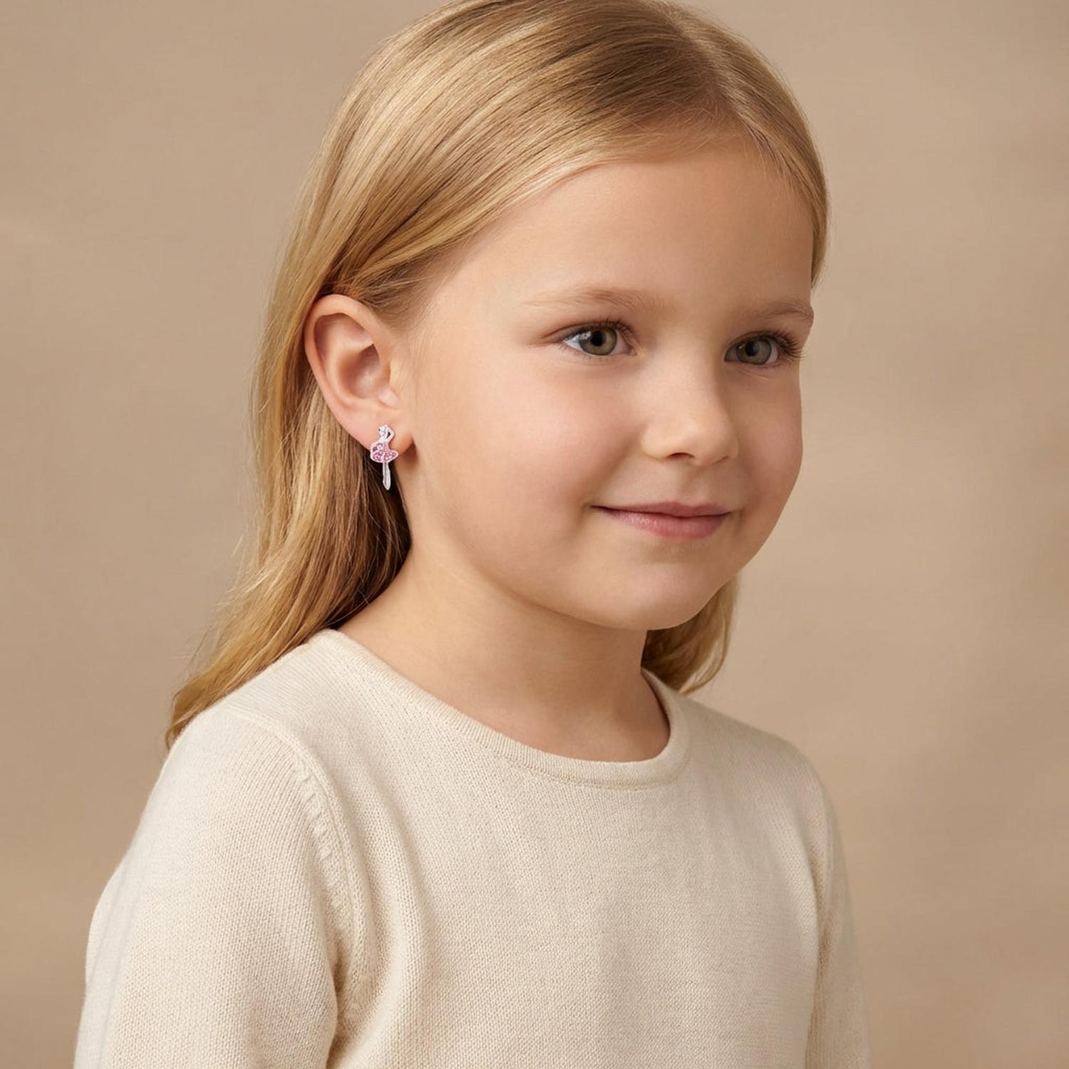 Melchior Jewellery ballerina earrings for girls worn by a young girl with blonde hair in a cream top
