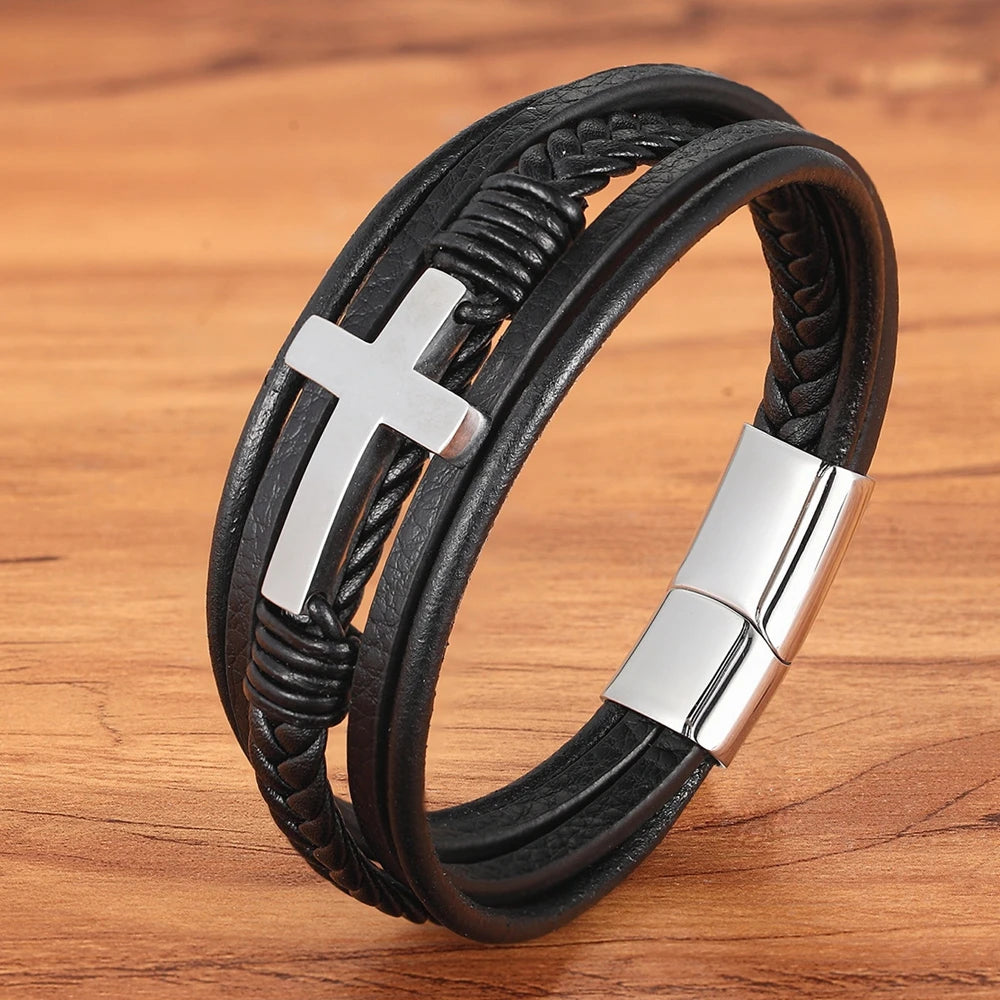 Melchior Jewellery braided leather bracelet for men with silver cross and magnetic clasp on wooden surface