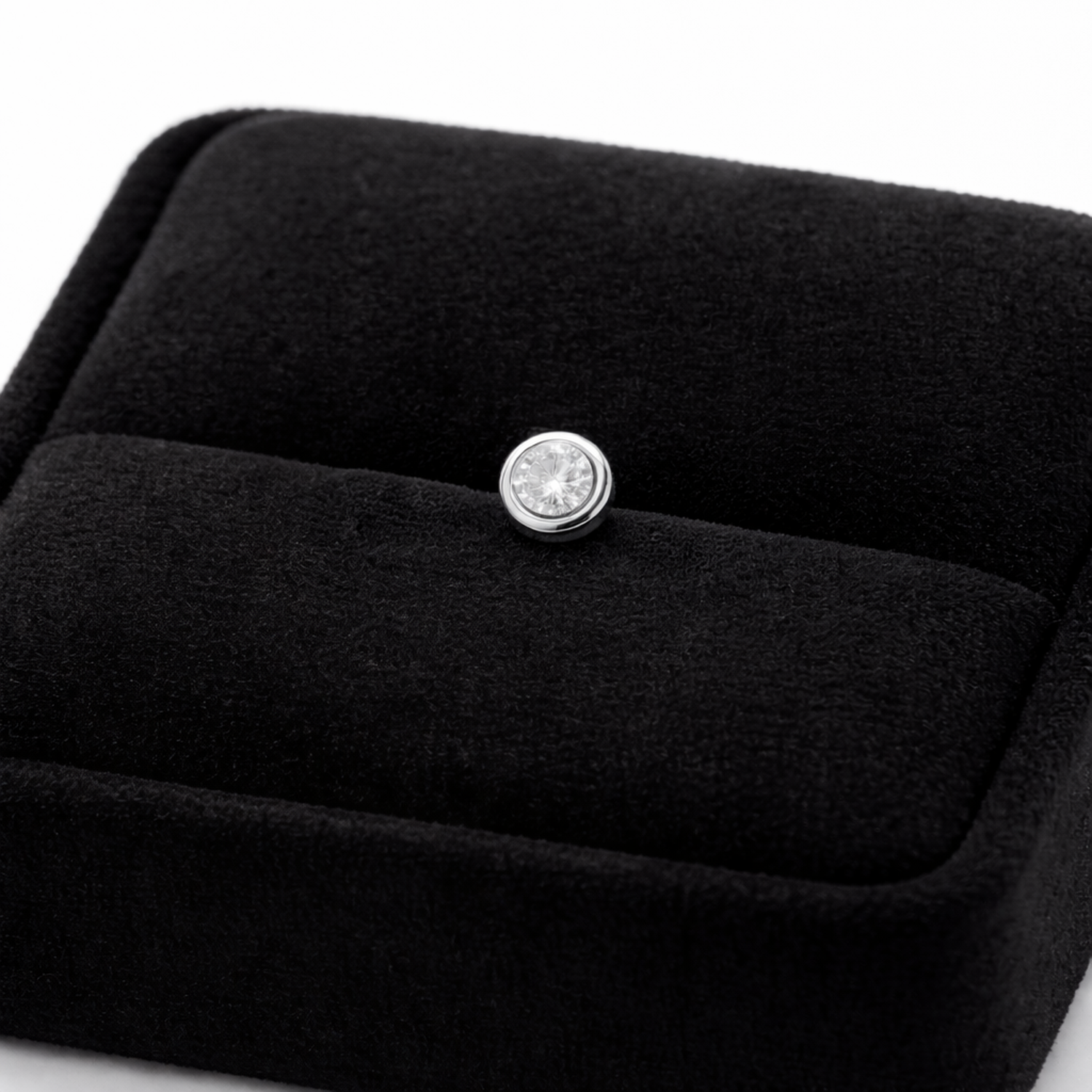Brilliant cut single stud earring for men displayed on black velvet jewellery box