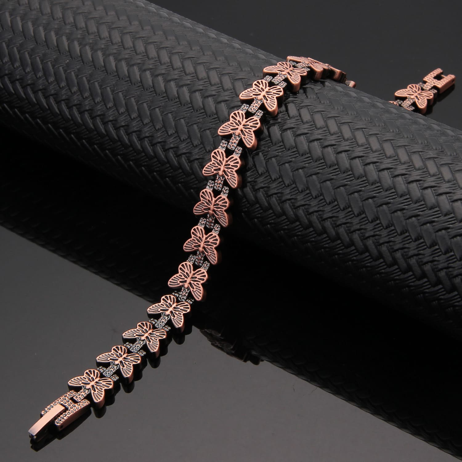 Melchior Jewellery rose gold butterfly link bracelet on black display butterfly design magnetic therapy bracelet