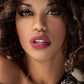Melchior Jewellery coloured steel segment ring septum on model with curly hair bold eye makeup and mauve lips