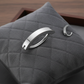 Melchior Jewellery sleek silver body jewellery hoop pieces on grey quilted cushion