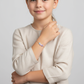 Child wearing Melchior Jewellery colourful flower bracelet for kids with pastel flower charms on silver chain