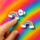 Melchior Jewellery colourful rainbow stud earrings girls shown on vibrant background with child’s finger