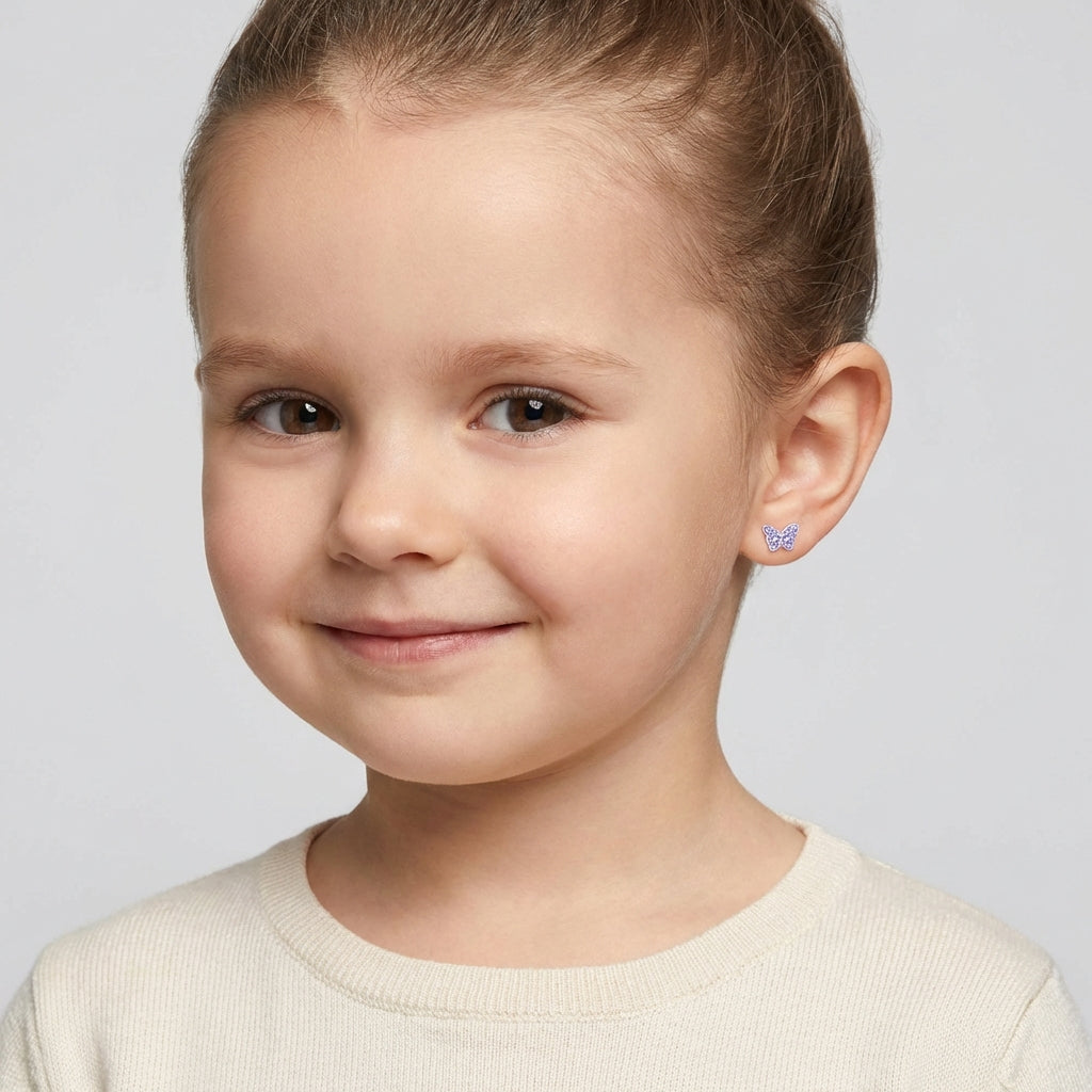 Crystal butterfly screw back earrings for kids worn by a smiling girl, Melchior Jewellery children's earrings