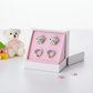 Crystal paw and heart earrings for kids displayed in a pink and white jewellery box by Melchior Jewellery