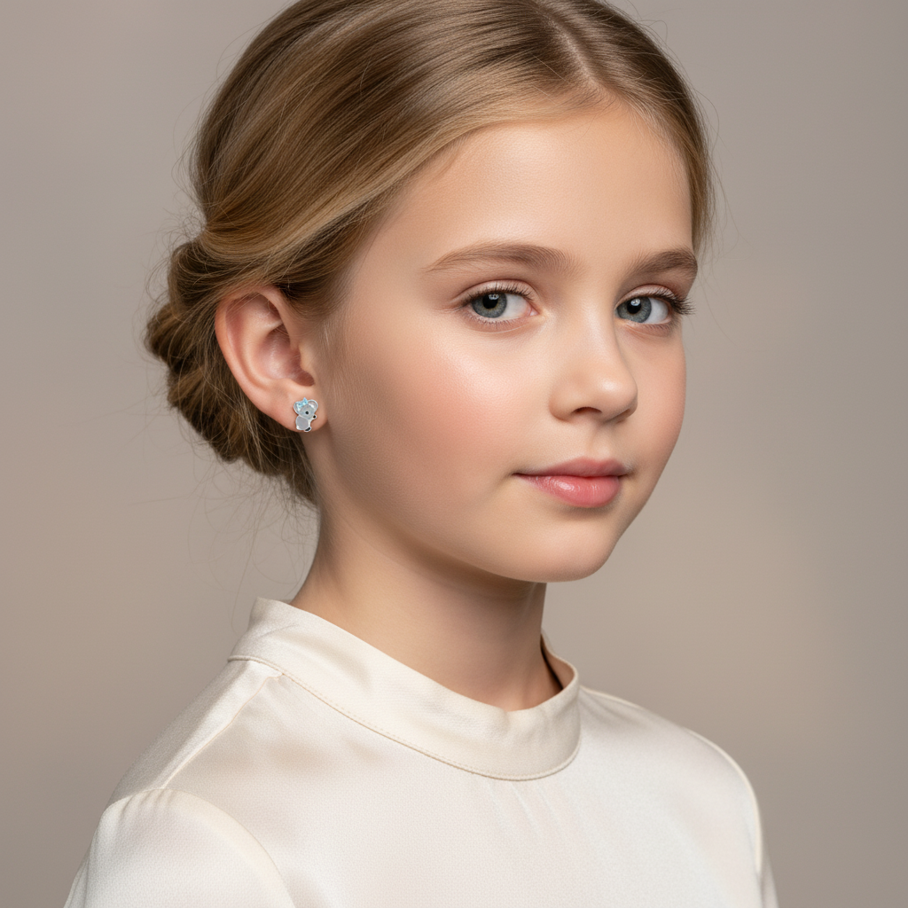 Young girl wearing cute koala earrings for girls by Melchior Jewellery with a soft smile
