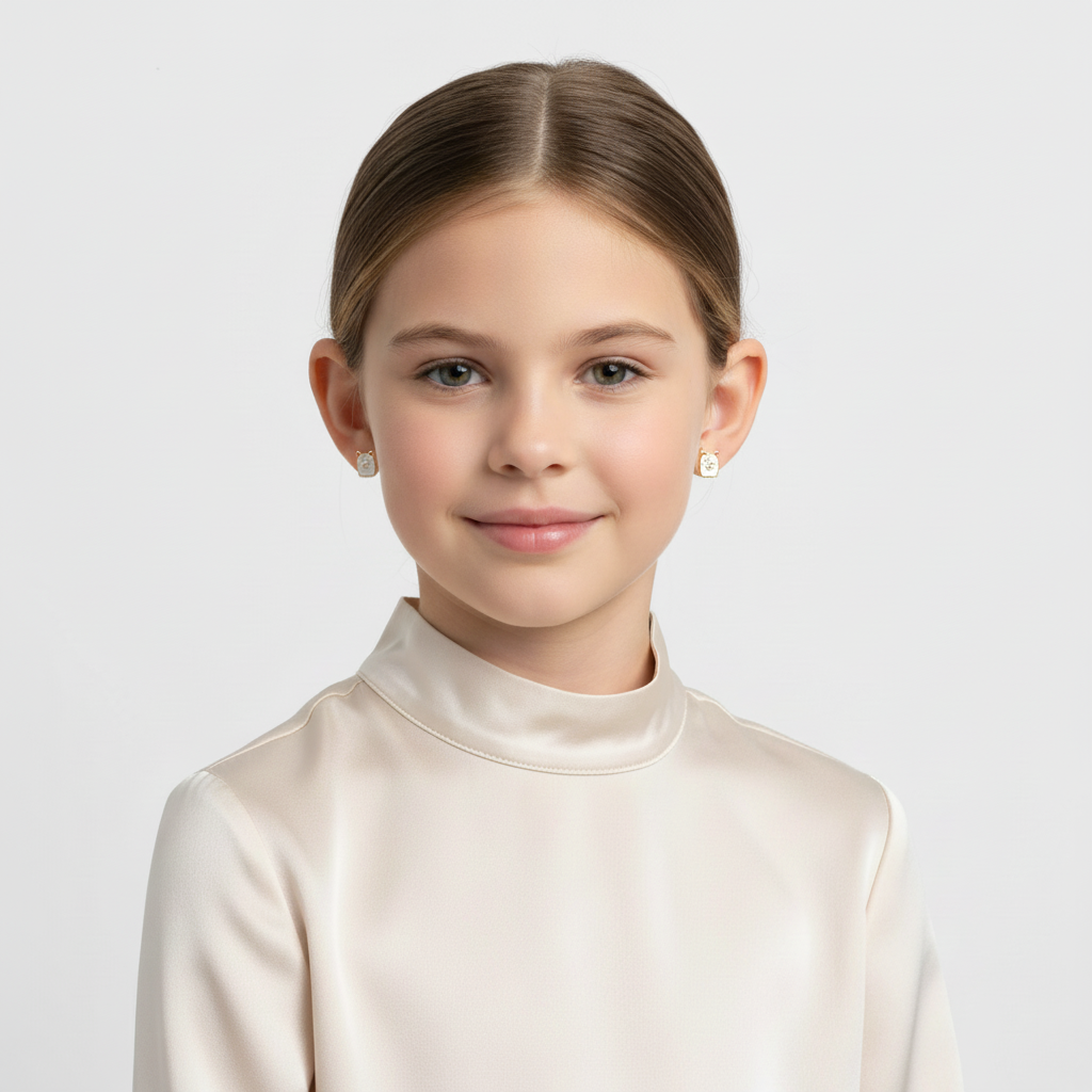 Young girl wearing cute llama earrings for kids by Melchior Jewellery with a soft smile