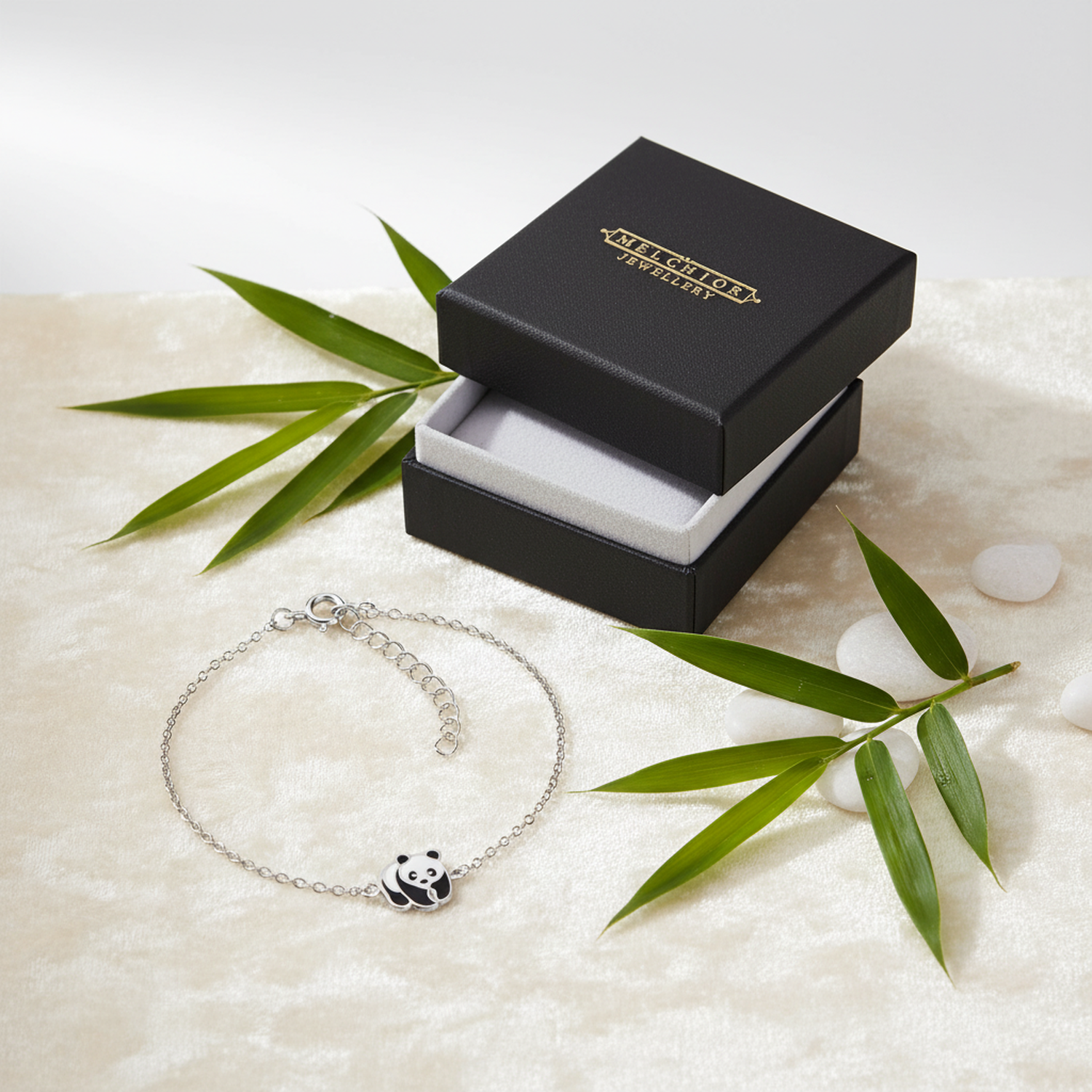 Melchior Jewellery cute panda bear bracelet for kids displayed next to an open black gift box with green leaves