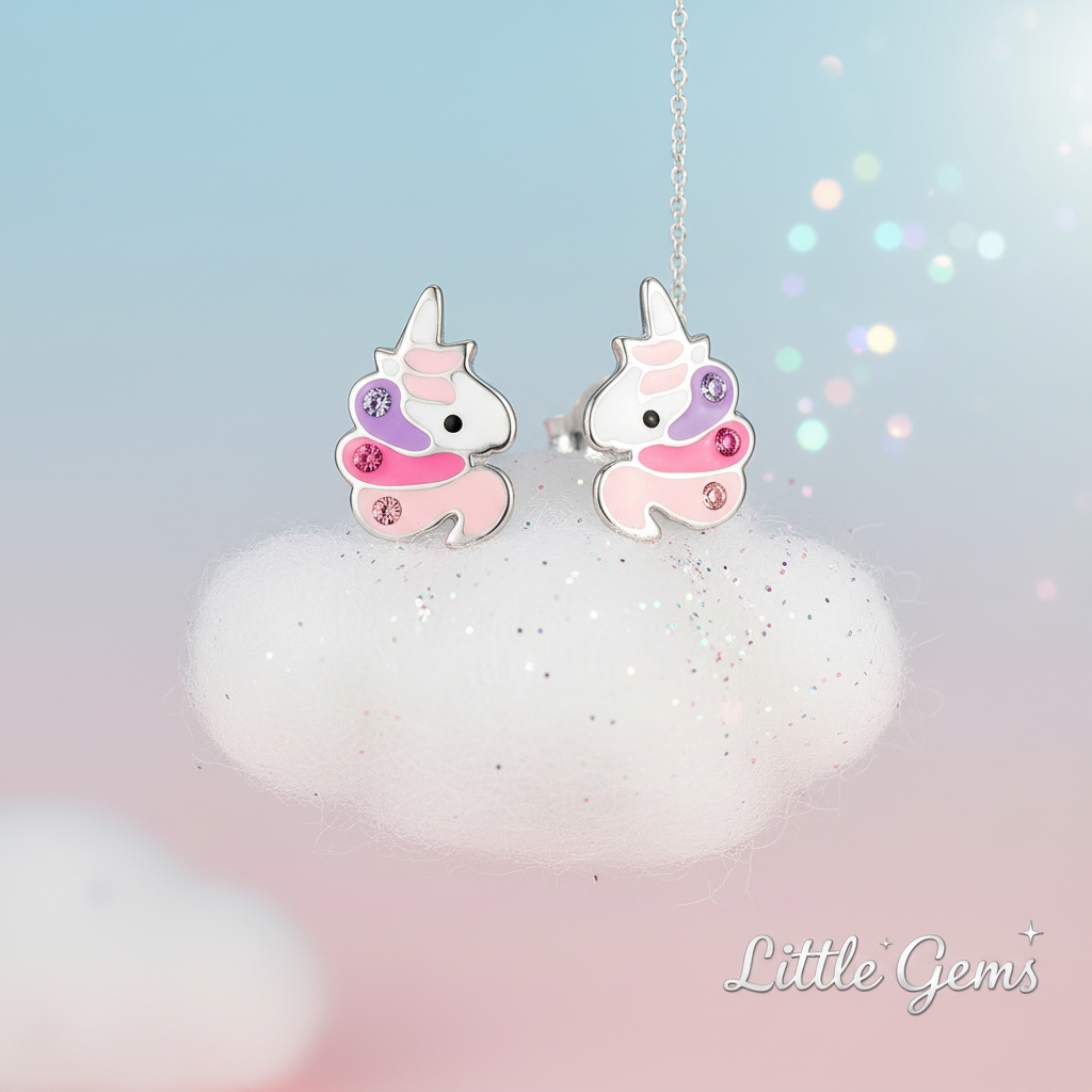 Cute unicorn CZ earrings for kids by Melchior Jewellery displayed on a fluffy cloud background