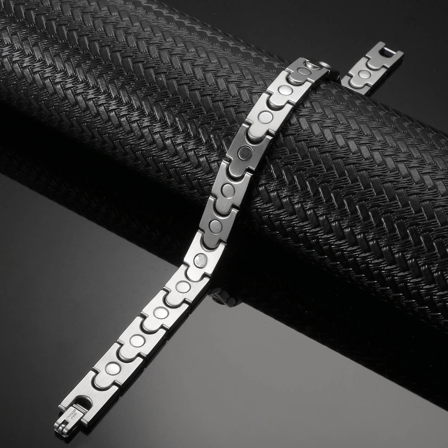 Melchior Jewellery dual-tone magnetic bracelet with sleek silver and black links on black textured display