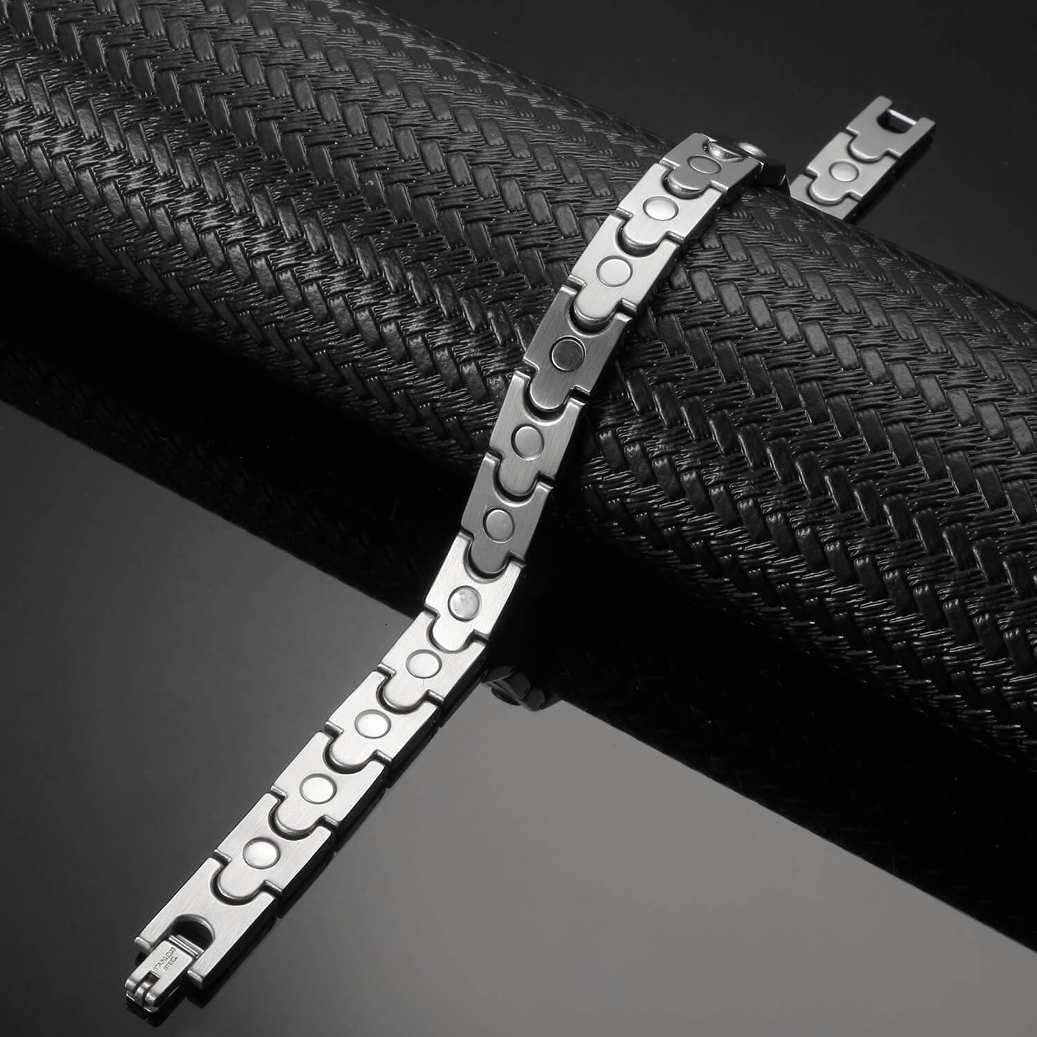 Melchior Jewellery dual-tone magnetic bracelet with sleek silver and black links on black textured display