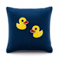 Melchior Jewellery duck stud earrings for kids in yellow and red on a navy blue pillow