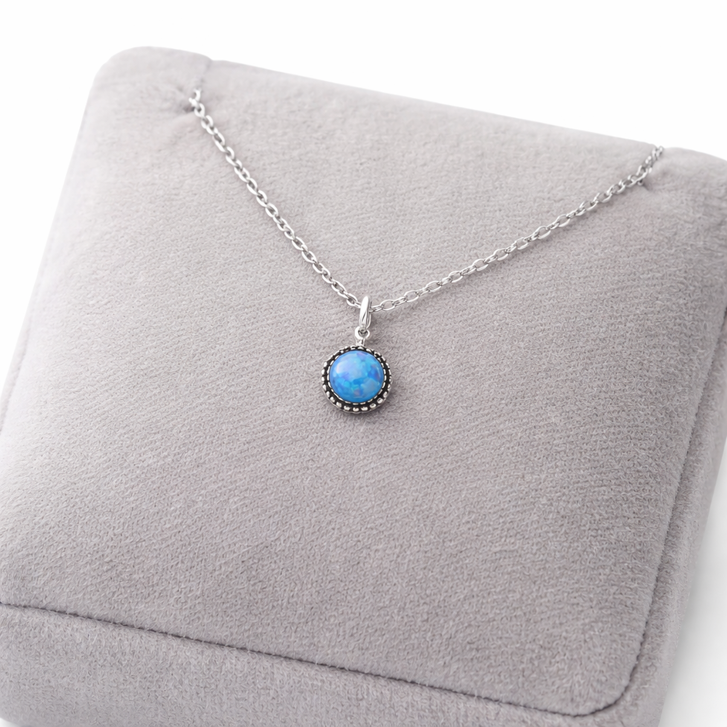 Melchior Jewellery elegant blue gemstone pendant necklace with silver chain on grey cushion