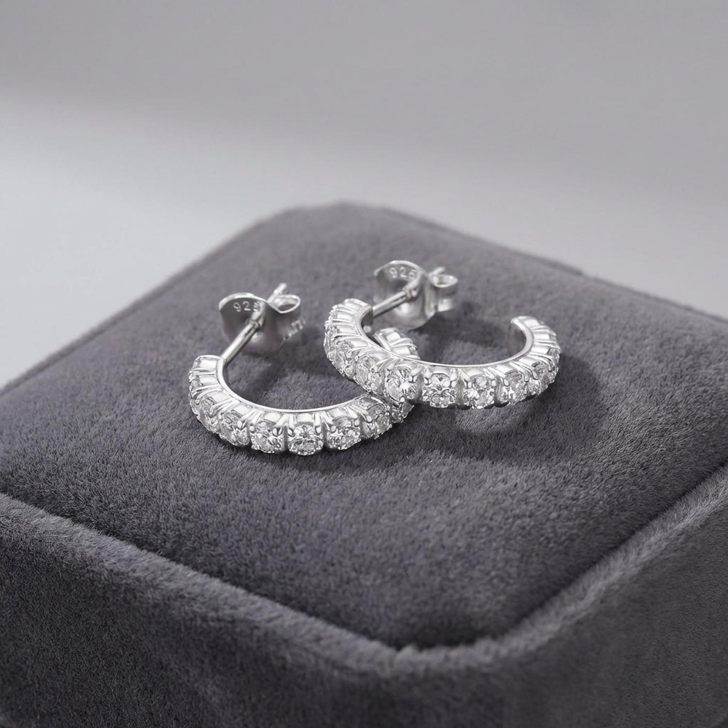 Elegant silver half hoop earrings for gifts by Melchior Jewellery displayed on grey velvet cushion