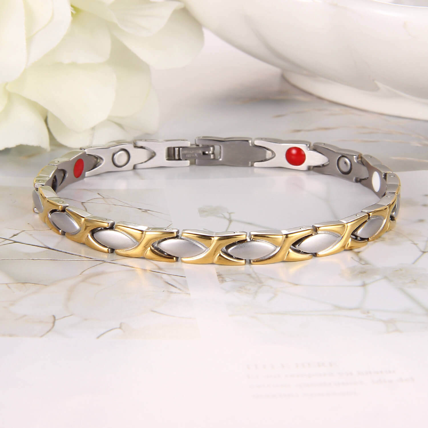 Elegant two tone magnetic bracelet by Melchior Jewellery featuring gold and silver links on marble surface