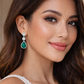Melchior Jewellery Emerald Icon Drops Earrings with green teardrop gemstones worn by woman