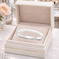 Melchior Jewellery expandable heart baby bracelet in silver displayed in a luxury cream jewellery box