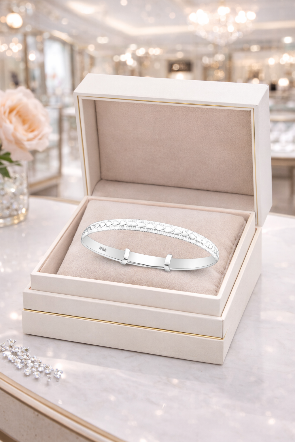 Melchior Jewellery expandable heart baby bracelet in silver displayed in a luxury cream jewellery box