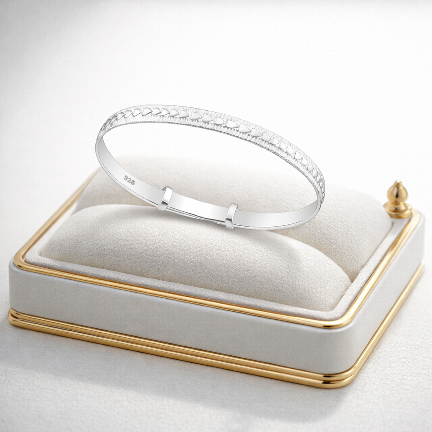 Melchior Jewellery expandable heart baby bracelet in silver displayed on a white cushioned jewellery box